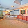 Bathroom Remodel in Mill Creek, WA: Bathroom Floor - Heated Limestone Tile Floor, Granite Counter Top with Undermounted Sinks and Custom Natural Stone Back Splash