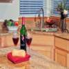 Kitchen Remodel Everett, WA: New 3cm Granite Counter Tops with new Stainless Steel Undermounted Sink and Custom Travertine Back Splash