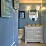 Bathroom Remodel Seattle, WA: Granite Counter Top, Custom Tile Back Splash, Ceramic 12x12 Tile Flooring, HET Toilet, Custom Shower with Natural Stone River Rock Floor