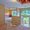 House Repair Edmonds, WA: BEFORE Picture of the hall way/dining room area pre-restoration. Ceiling is destroyed by a fallen tree, wall finishes are destroyed by rain water, carpets are covered in mold, mill work needs replacing