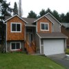 House Remodel Everett, WA: AFTER - New Fiber-Cement Pre-Painted Siding (Maxi Plank), New Fascia Boards, New Gutters, Additional Exterior Lighting Installed, Cedar Shingle Siding Accents Installed, All Windows and Doors are trimmed out. Front Porch Remodel - New Synthetic Material (TimberTech color: Teak) 