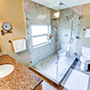 Everett 1901 Home Master Bath After;Obscured glass Privacy window inside the Frameless glass shower enclosure. Shower floor is travertine mosaic tile.
