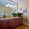 Bathroom Remodel Mill Creek, WA: Bathroom Floor - Limestone Tile Floor, Mahogany Cabinets, Granite Counter Top with Undermounted Sinks and Custom travertine Back Splash, as well as a full mirror trim. Motion censored under cabinet (toe kick) LED night lighting