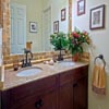 Bathroom Remodel Mill Creek, WA: Bathroom Floor - Limestone Tile Floor, Mahogany Cabinets, Granite Counter Top with Undermounted Sinks and Custom travertine Back Splash, as well as a full mirror trim. Motion censored under cabinet (toe kick) LED night lighting