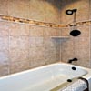 Bathroom Remodel Mill Creek, WA: Bathroom Floor - Limestone Tile Floor. Porcelain 12x12 shower/tub surround. Delta Mixer Valve and Trim in Oil Rubbed Bronze. Custom travertine accent row, and fully tiled bathroom walls