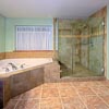 Bathroom Remodel, Bothell, WA: Removed old shower enclosure as well tub surround. Repaired/replaced all water-damaged framing members and sub-flooring. Installed new WEDI shower system, new tub enclosure and new counter tops. Shower Floor: Aspen Lodge (shadow pine) octagon. Shower Walls: Aspen Lodge (shadow pine) 12x12 porcelain tile. Custom 3/8 glass frameless shower glass enclosure and much more.
