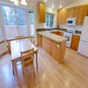 Kitchen Remodel, Woodinville, WA: New Red Oak engineered hardwood floor. New Honey Maple shaker style cabinets. Tiled counter tops with custom tiled back splash. New stainless steel drop in sink. All new kitchen appliances including new gas range, vented microwave and a new refrigerator.