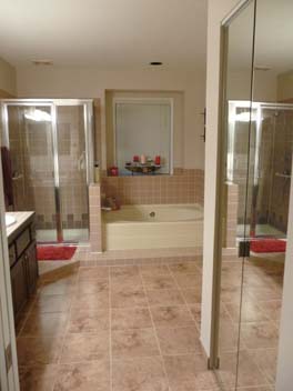 Existing bathroom features pink glazed ceramic tile for the shower surround, as well as the tub surround. Bathroom floor is 12x12 porcelain tile. Existing tub is almond color fiber-glass with offset drain. Existing cabinets are oak, that had been painted over with brown paint. Counter tops are laminated with drop-in sinks. Existing bathroom has only one recessed light fixture above the tub.